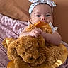 baby, bed, blanket, child, closeup, comfort, cozy, cute, flower_pattern, happy, headband, holding, indoors, infant, plush_toy, portrait, sleepwear, smiling, soft_texture, teddy_bear