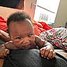Jaziriah is registered to the contest to win money with this photo: air_conditioner, baby, bed, blanket, colorful, comfort, cozy, curtain, face, hair, hand, indoor, infant, lying_down, person, room, skin, sleepwear, soft_light, window