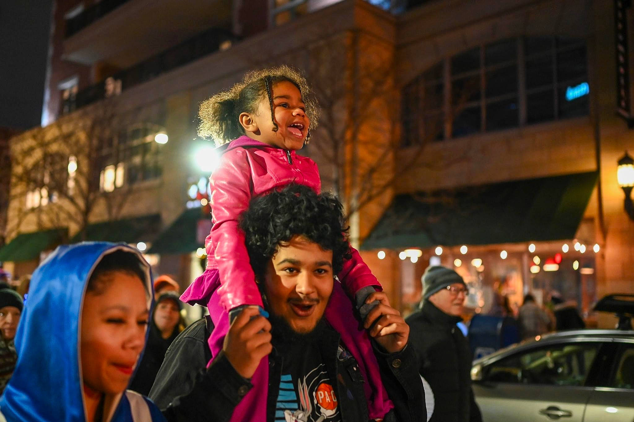 Janiyah is registered to the contest to win money with this photo: car, city, crowd, entertainment, event, fun, happy, headwear, joy, leisure, luxury_vehicle, magenta, mid_size_car, night, pedestrian, person, personal_luxury_car, public_event, recreation, road