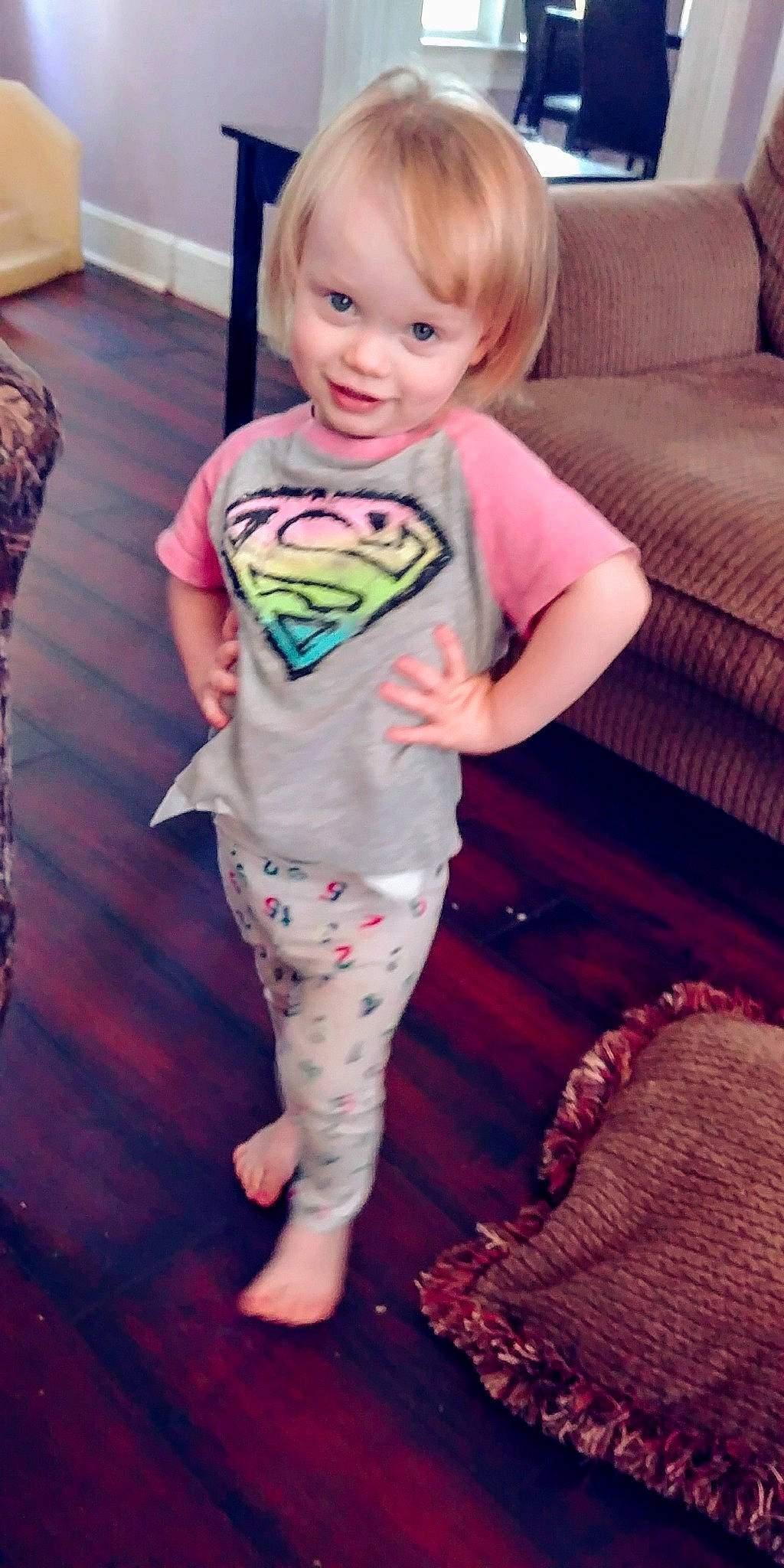 Veda is registered to the contest to win money with this photo: arm, child, day, finger, floor, flooring, girl, human_hair_color, infant, leg, organ, person, pink, play, product, sitting, skin, standing, textile, toddler