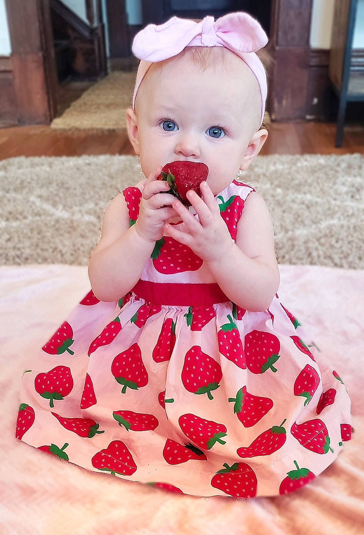 Primrose is registered to the contest to win money with this photo: arm, baby, baby_toddler_clothing, child, dress, event, happy, magenta, nail, pattern, person, petal, pink, red, sitting, skin, sleeve, sweetness, textile, toddler