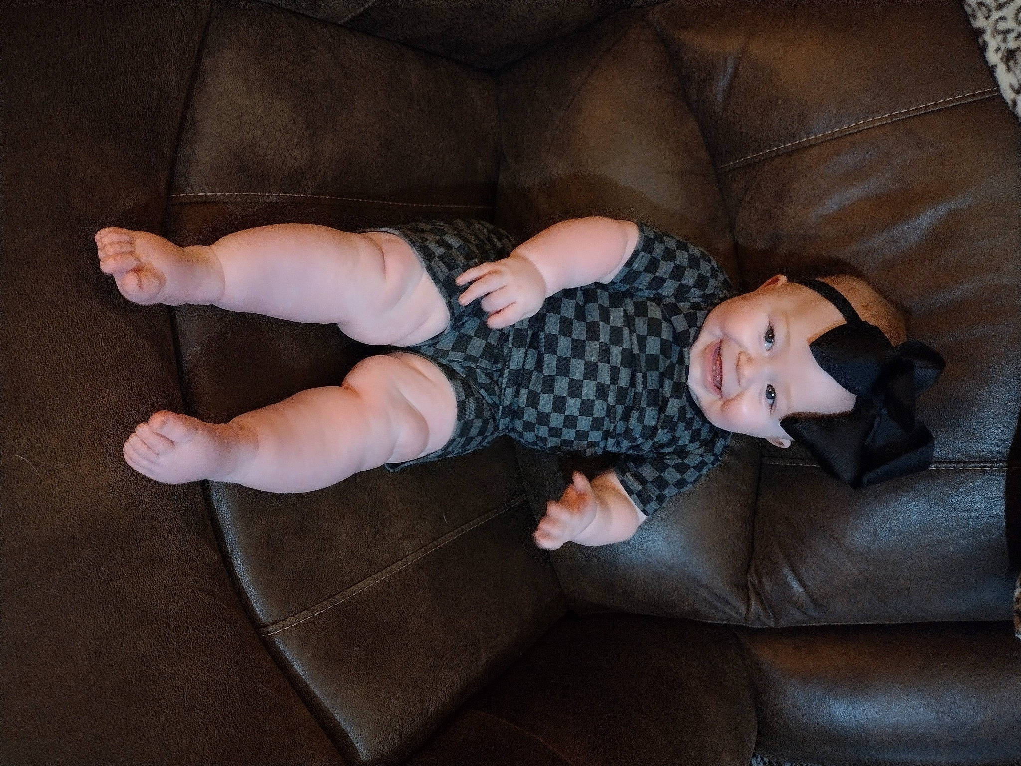 Raelynn is registered to the contest to win money with this photo: baby, baby_toddler_clothing, barefoot, child, comfort, couch, finger, flooring, foot, human_leg, joy, knee, leg, linens, person, sitting, sleeve, sock, thigh, toddler