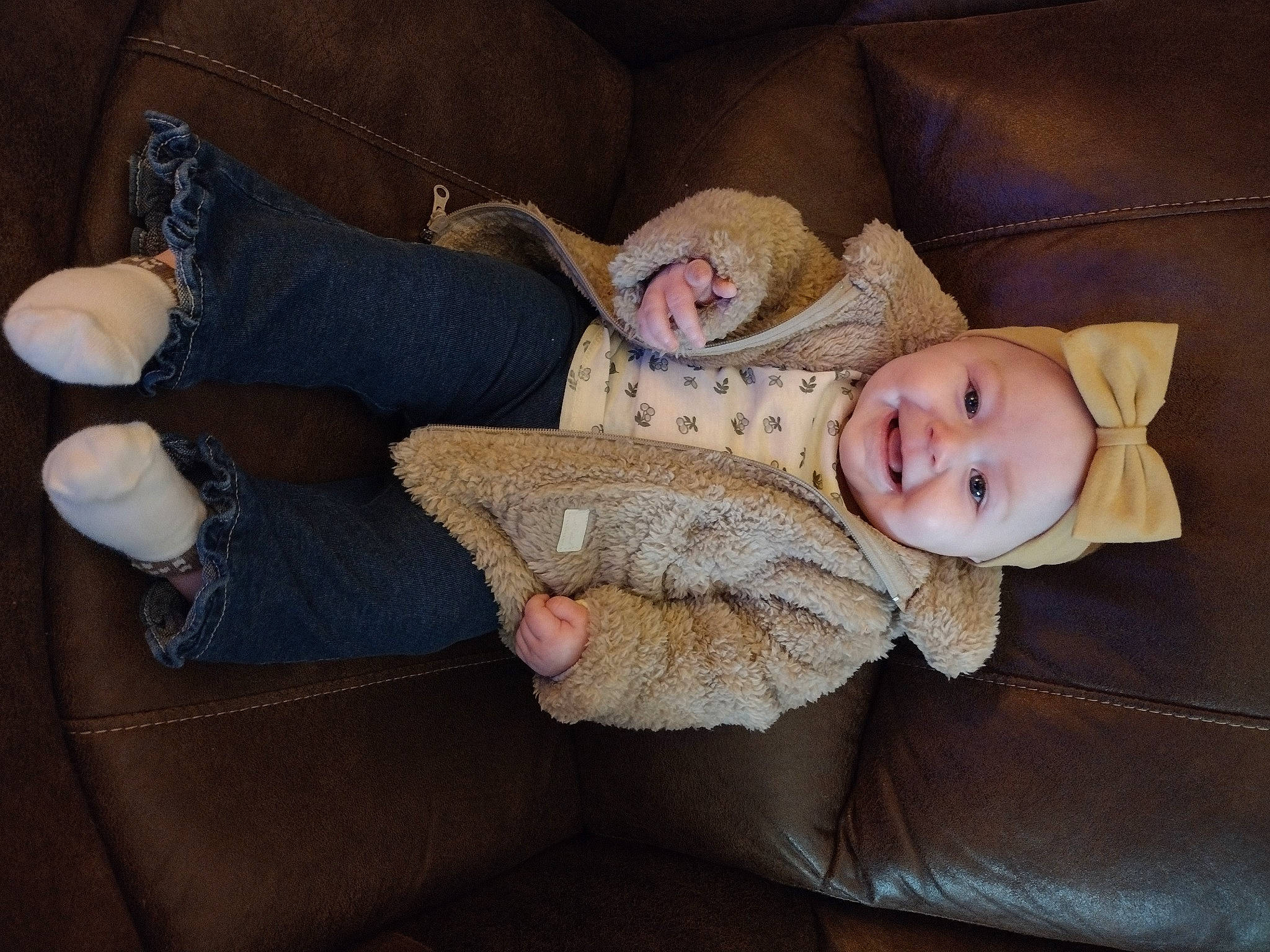 Raelynn joined the competition — help win amazing prizes! baby, child, comfort, couch, eye, finger, foot, fur, human_leg, joy, knee, lap, leg, linens, person, sitting, skin, smile, thigh, toddler