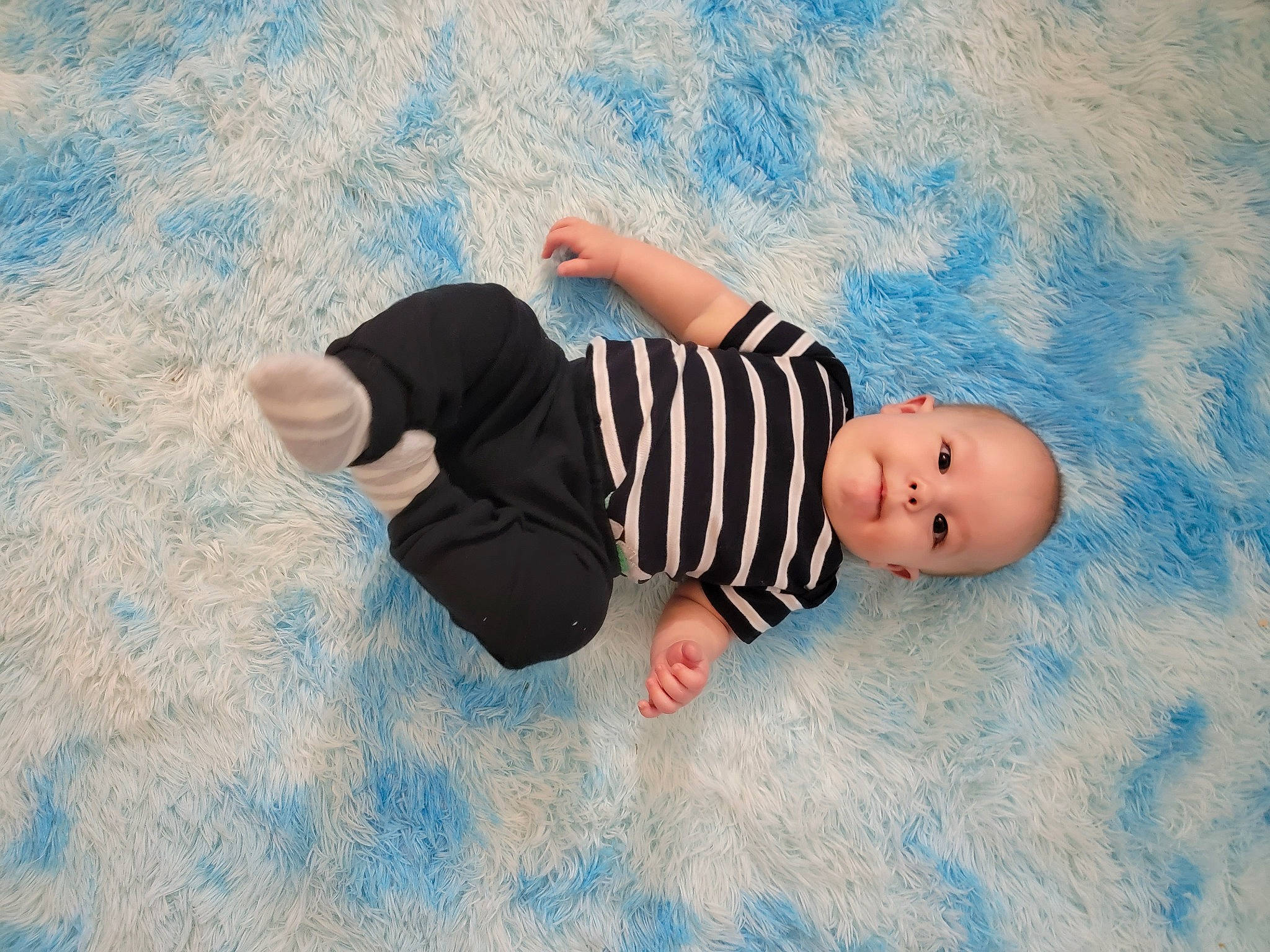 Sebastian is registered to the contest to win money with this photo: arm, azure, baby, beach, blue, cloud, finger, flash_photography, flooring, fun, grass, hand, happy, leisure, people_in_nature, person, product, skin, sky, toddler
