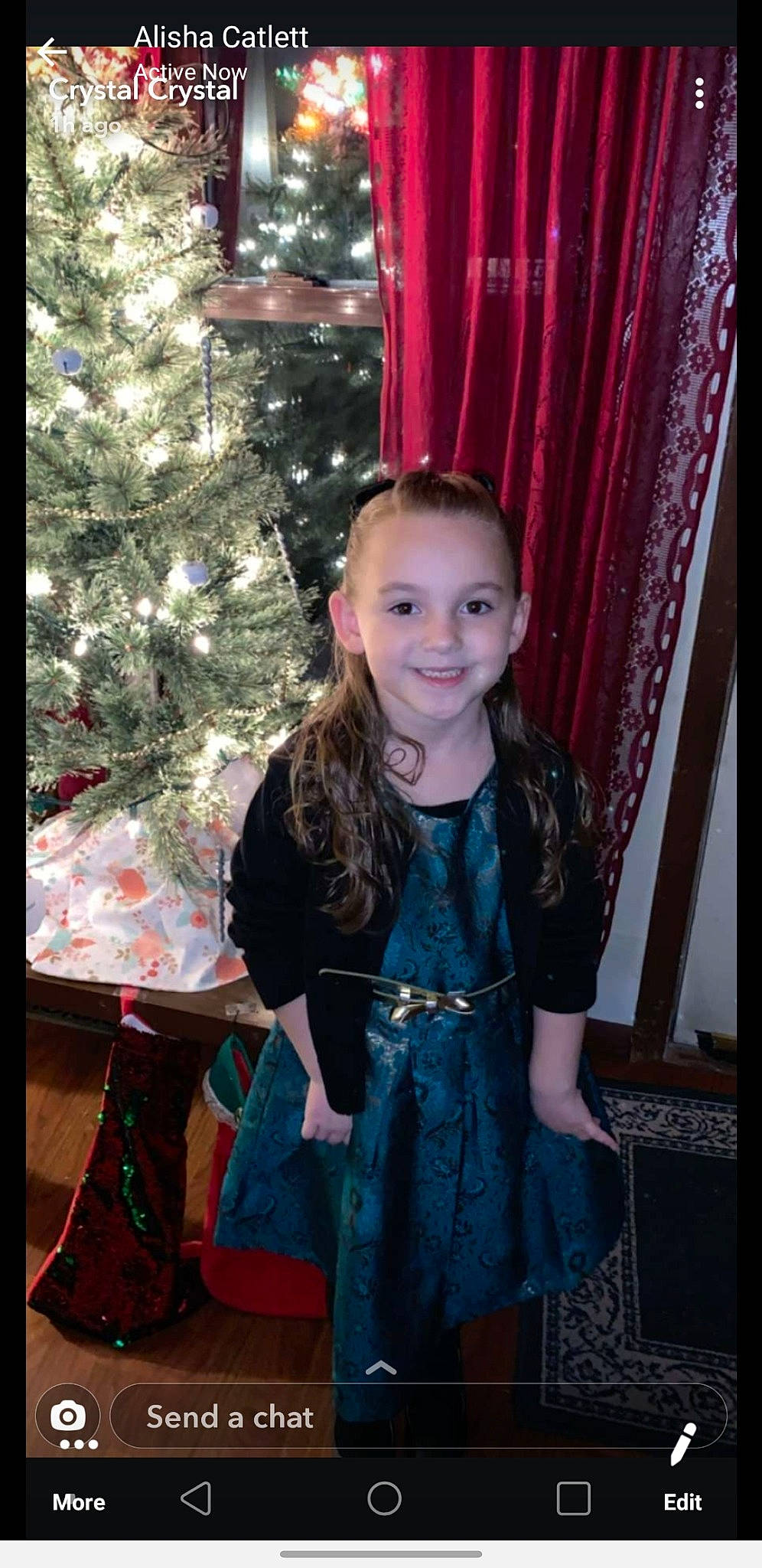 Macara is registered to the contest to win money with this photo: child, child_model, christmas, christmas_tree, costume, dress, hair, hairstyle, holiday, interior_design, iris, joy, long_hair, outerwear, person, smile, standing, textile, toddler