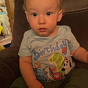 Elijah joined the competition — help win amazing prizes! baby, child, birthday, shirt, socks, chair, indoor, cute, expression, face, person, young, seated, clothing, home, celebration, mismatch_socks, curious, infant, portrait