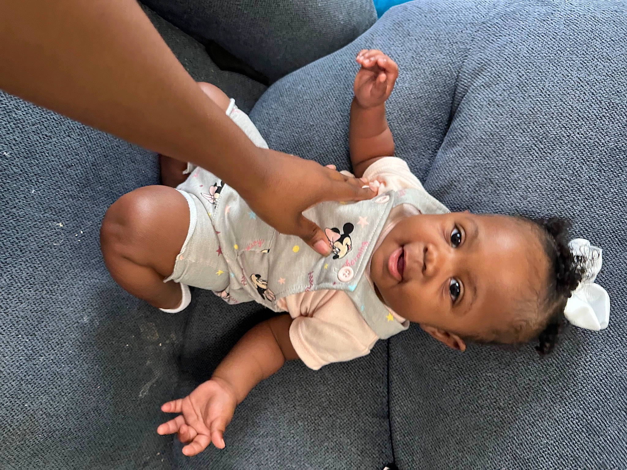 Laylani is registered to the contest to win money with this photo: baby, baby_toddler_clothing, child, comfort, elbow, eye, finger, foot, gesture, grass, hat, human_body, human_leg, joint, knee, mammal, nail, person, skin, thigh