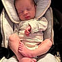 newborn, baby, sleeping, car_seat, infant, feet, hands, clothing, soft_fabric, cloud_pattern, peaceful, cute, child, seatbelt, portrait, indoors, head_support, relaxation, comfort, tiny_toes
