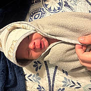 Ryder joined the competition — help win amazing prizes! newborn, baby, towel, hand, blanket, hooded_towel, sleepy, wrapped, infant, soft_texture, pattern, bed, cozy, cute, skin, person, portrait, resting, comfort, indoors