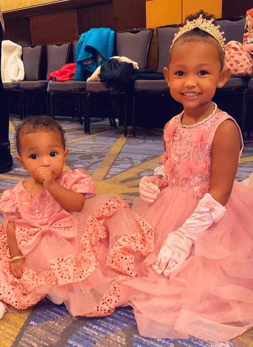 Nakia is registered to the contest to win money with this photo: baby_toddler_clothing, cheek, child, chin, dress, embellishment, eye, face, facial_expression, fun, hairstyle, happy, head, iris, joy, organ, person, pink, skin, smile