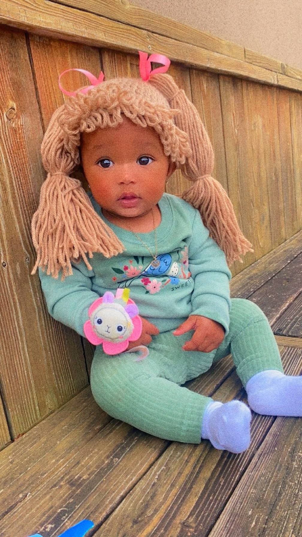 Naylani is registered to the contest to win money with this photo: baby_toddler_clothing, bangs, blond, brown_hair, child, doll, eyelash, flooring, fun, grass, happy, head, headwear, jewellery, magenta, person, pink, skin, surprise, toddler