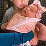 Carson is registered to the contest to win money with this photo: baby, bodypart, clothing, couch, cushion, face, finger, furniture, hand, head, homedecor, kissing, newborn, person, photography, portrait, romantic, shorts, sleeping, t_shirt