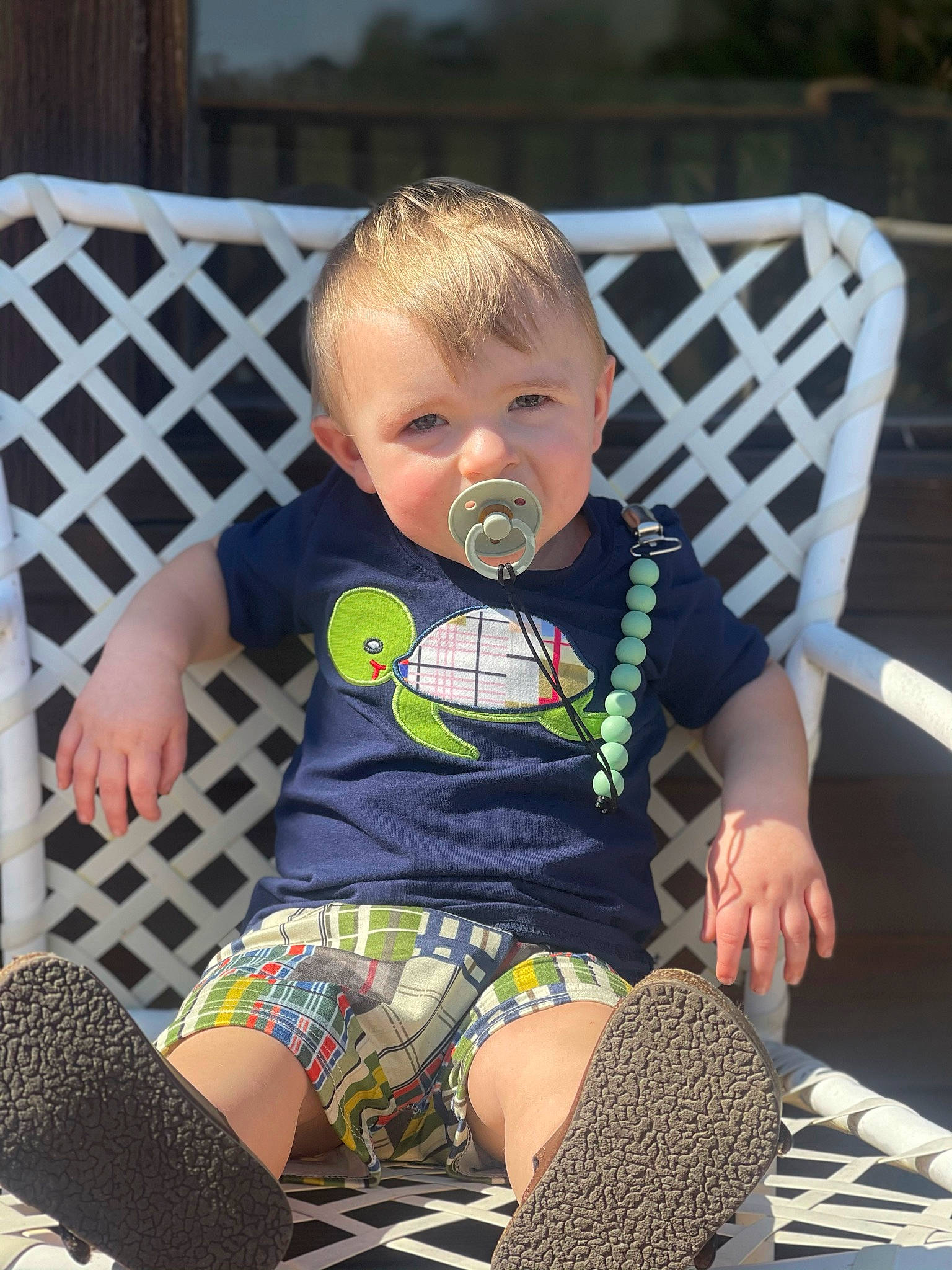 Clayton joined the competition — help win amazing prizes! baby, baby_toddler_clothing, black, chair, cheek, comfort, eye, face, facial_expression, grass, head, iris, lap, leg, person, skin, sleeve, textile, thigh, toddler