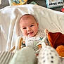 Louis participe au concours pour gagner de l'argent avec cette photo : baby, smiling, blanket, toy, soft_toy, book, child, infant, cute, happy, indoors, playtime, colorful, face, portrait, lying_down, soft, comfort, young, expression