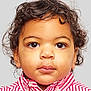 toddler, child, face, portrait, curly_hair, eyes, shirt, striped_shirt, red, white, young_child, expression, close_up, innocent, cute, person, studio_photo, casual_clothing, head_and_shoulders, neutral_expression