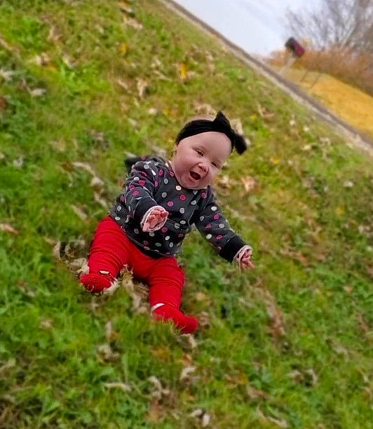 Emma is registered to the contest to win money with this photo: baby, baby_toddler_clothing, grass, grassland, happy, headwear, landscape, leaf, mammal, pasture, people_in_nature, person, plant, prairie, recreation, sleeve, smile, soil, toddler, tree