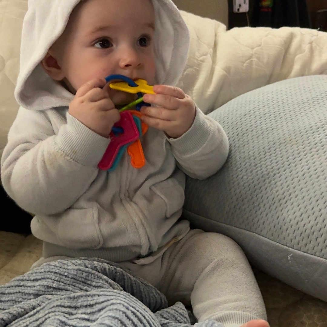 Mason joined the competition — help win amazing prizes! baby, blanket, child, comfort, couch, cozy, curious, cute, face, foot, hand, hoodie, indoor, infant, keys, pillow, sitting, soft, toy, white_clothing