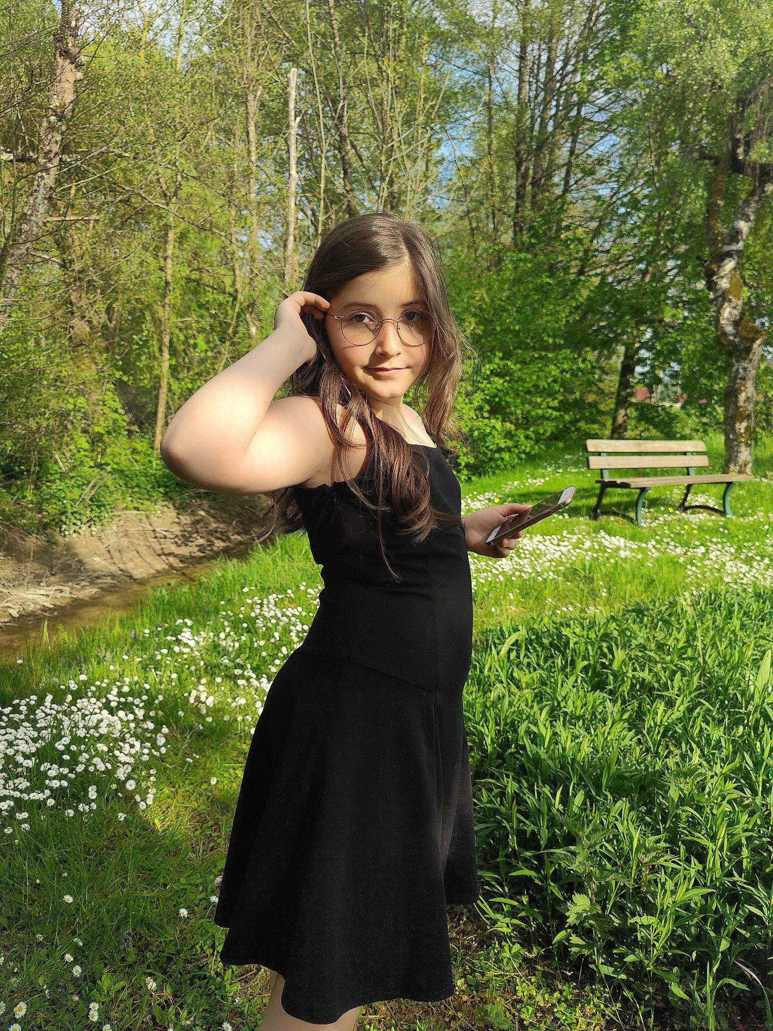 Mélisa participe au concours pour gagner de l'argent avec cette photo : black_hair, brown_hair, day_dress, eyewear, flash_photography, forest, formal_wear, grass, grass_family, joy, long_hair, one_piece_garment, people_in_nature, person, plant, shoulder, shrub, sleeve, sunlight, tree