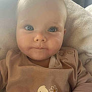 Jade participe au concours pour gagner de l'argent avec cette photo : baby, infant, face, blue_eyes, hair_clip, brown_clothing, chick_print, flowers, blanket, closeup, cute, child, soft_light, indoors, portrait, sitting, skin, expression, buttoned_shirt, warmth