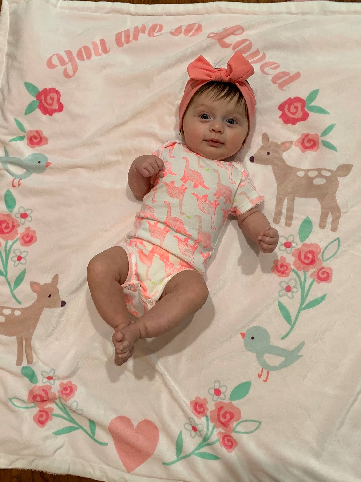 Emma is registered to the contest to win money with this photo: baby, baby_products, baby_toddler_clothing, child, headwear, linens, nap_mat, pattern, person, pink, product, textile, toddler