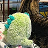 Fayh is registered to the contest to win money with this photo: animal, back_view, blanket, cat, chair, cozy, dinosaur_toy, fur, furniture, home, indoor, patterned_blanket, pet, plush_toy, resting, soft_toy, striped, stuffed_animal, tabby_cat, wooden_chair
