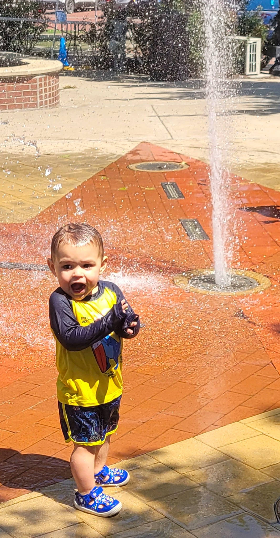 Archer is registered to the contest to win money with this photo: asphalt, beauty, fun, happy, human, leisure, line, person, photograph, public_space, road, road_surface, shorts, smile, snapshot, summer, toddler, travel, wall, water