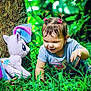 Roxan Paola is registered to the contest to win money with this photo: toddler, child, grass, tree, plush_toy, unicorn, outdoor, nature, greenery, pigtails, happy, crawling, cute, play, summer, casual_clothing, earrings, bracelet, daylight, smiling