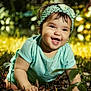 Roxan Paola is registered to the contest to win money with this photo: baby, child, smiling, headband, bow, grass, outdoor, nature, sunlight, green, cute, happy, portrait, infant, jewelry, necklace, earrings, crawling, toddler, daylight