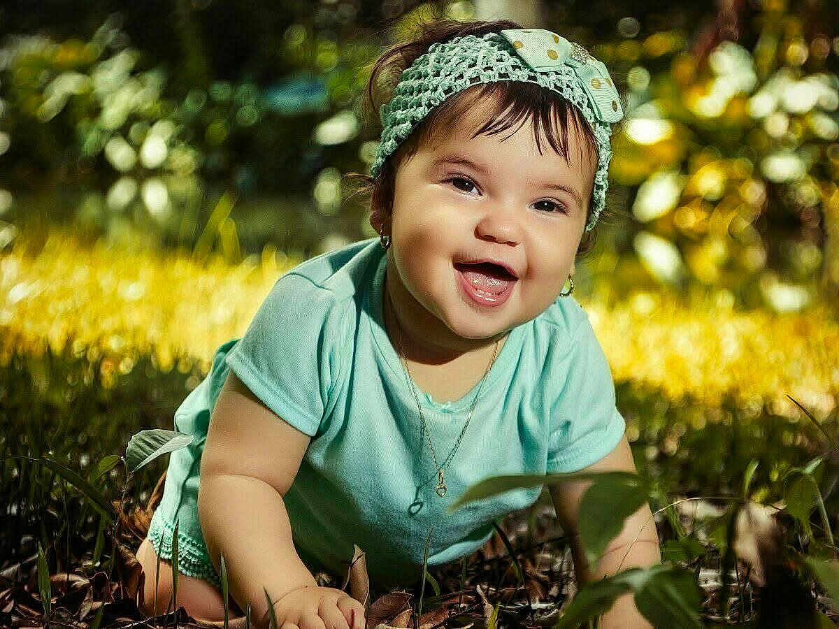 Roxan Paola is registered to the contest to win money with this photo: baby, child, smiling, headband, bow, grass, outdoor, nature, sunlight, green, cute, happy, portrait, infant, jewelry, necklace, earrings, crawling, toddler, daylight