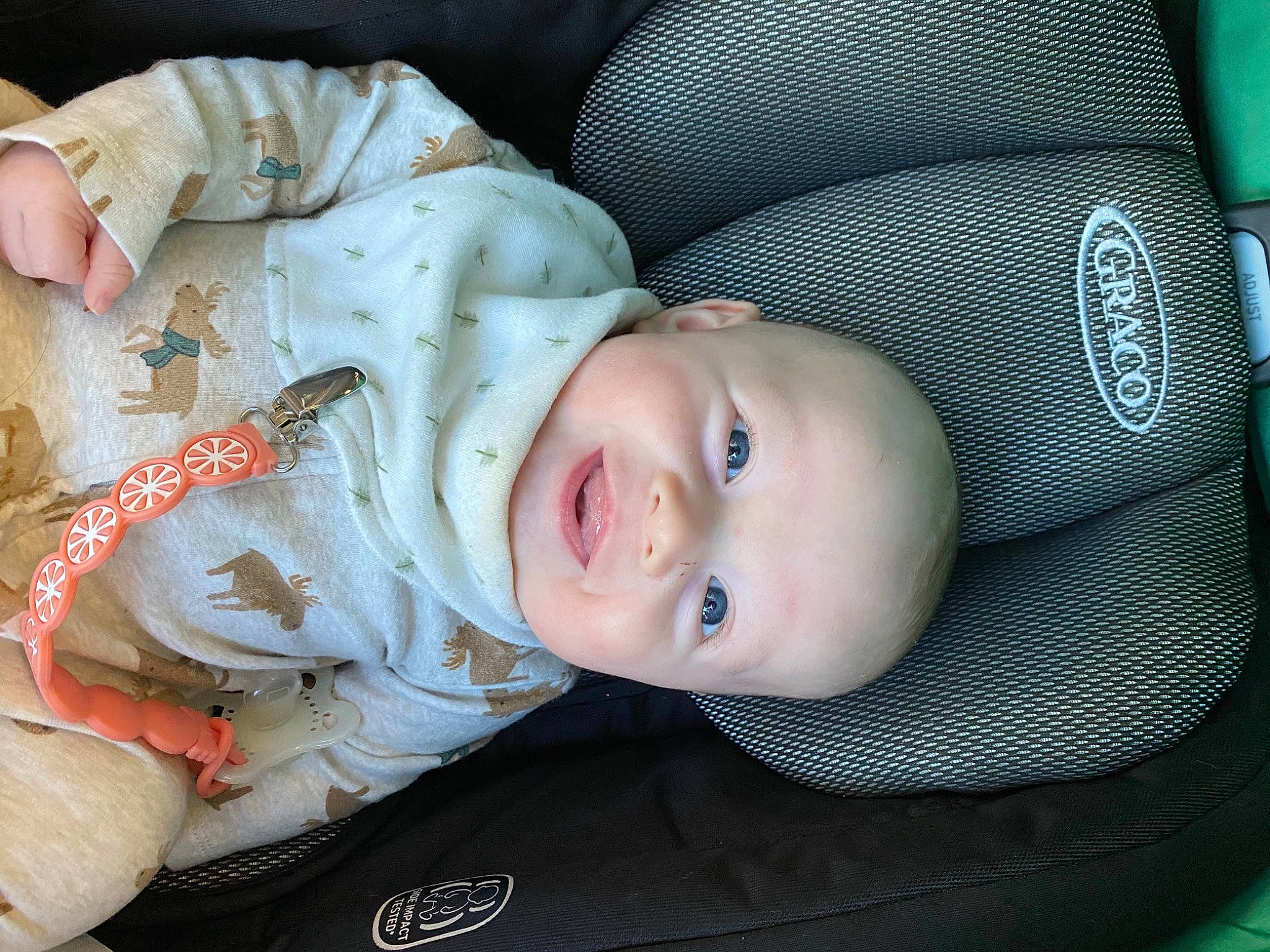 Weston is registered to the contest to win money with this photo: auto_part, baby, baby_products, baby_toddler_clothing, cheek, child, comfort, electric_blue, eyelash, fur, headgear, organ, pattern, person, product, sitting, skin, sleeve, smile, toddler