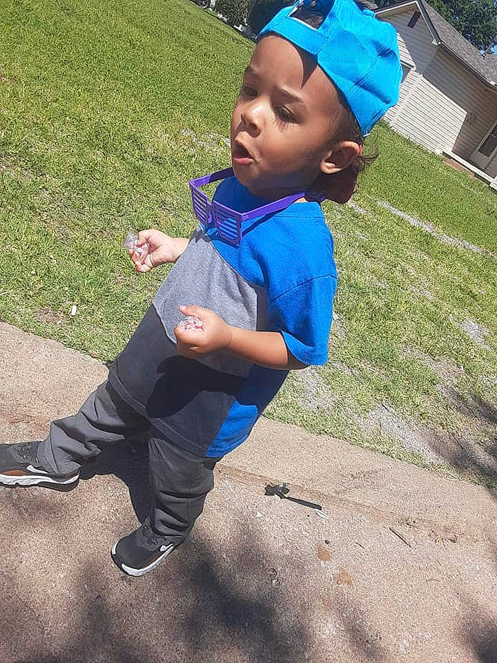 Ke'Moni is registered to the contest to win money with this photo: baby, blue, child, cool, fun, grass, head, headgear, headwear, leisure, person, photography, plant, play, playground, public_space, recreation, smile, toddler, vacation