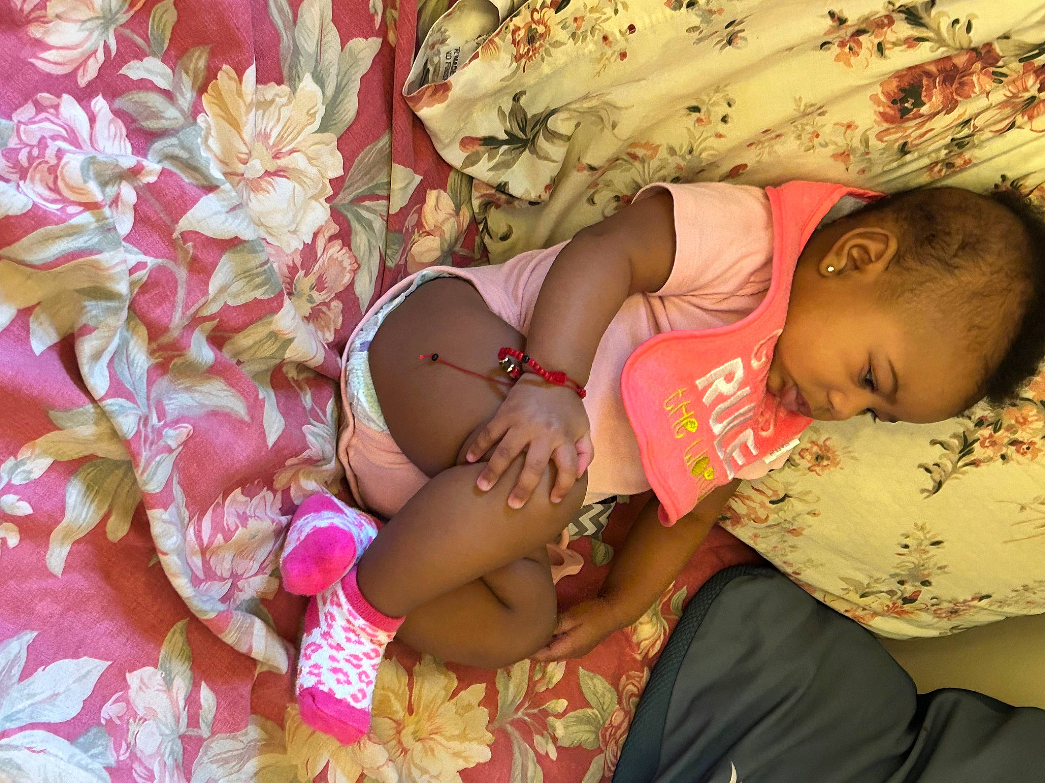 Kailani is registered to the contest to win money with this photo: abdomen, arm, baby, beauty, cheek, comfort, finger, fun, happy, human_body, leaf, muscle, pattern, people_in_nature, person, pink, skin, textile, thigh, toddler