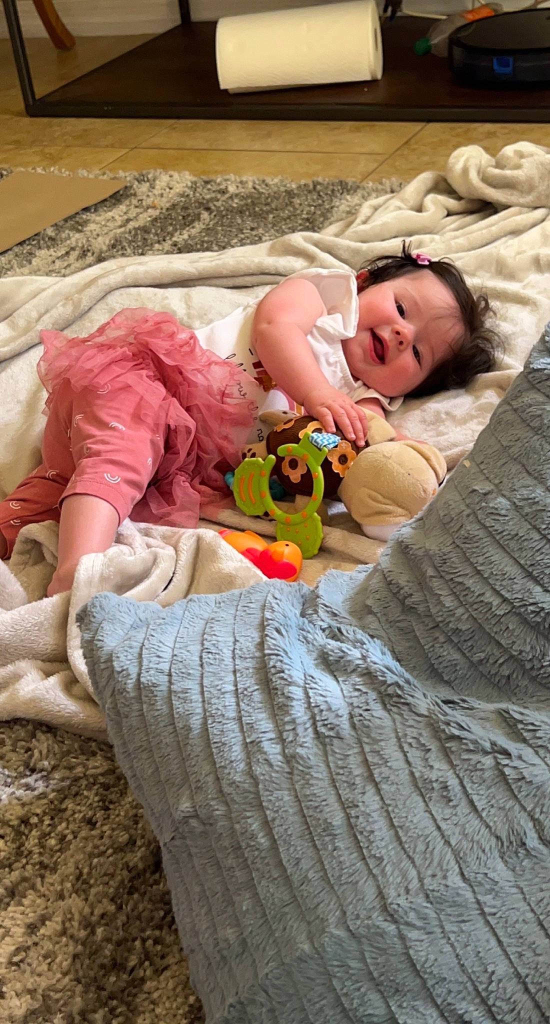 Kassidy is registered to the contest to win money with this photo: baby, baby_toddler_clothing, bedding, child, comfort, eye, fawn, fun, grass, happy, human_leg, leisure, linens, people, person, skin, smile, textile, thigh, toddler