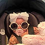 Lydia is registered to the contest to win money with this photo: baby, car_seat, sunglasses, headband, pacifier, blanket, child, infant, cute, fashion, pink, white, cozy, seatbelt, fluffy, accessory, portrait, indoor, soft, adorable