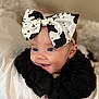 Lydia joined the competition — help win amazing prizes! baby, child, headband, bow, black_and_white, cute, face, eyes, smile, infant, clothing, portrait, closeup, soft, blanket, indoors, person, happy, young, expression