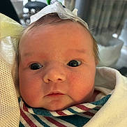 Roselynn is registered to the contest to win money with this photo: newborn, baby, infant, child, face, portrait, wide_eyes, serious_expression, swaddled, blanket, striped_blanket, hospital, medical_setting, gauze, headwear, lying_down, close_up, indoor, photography, cute