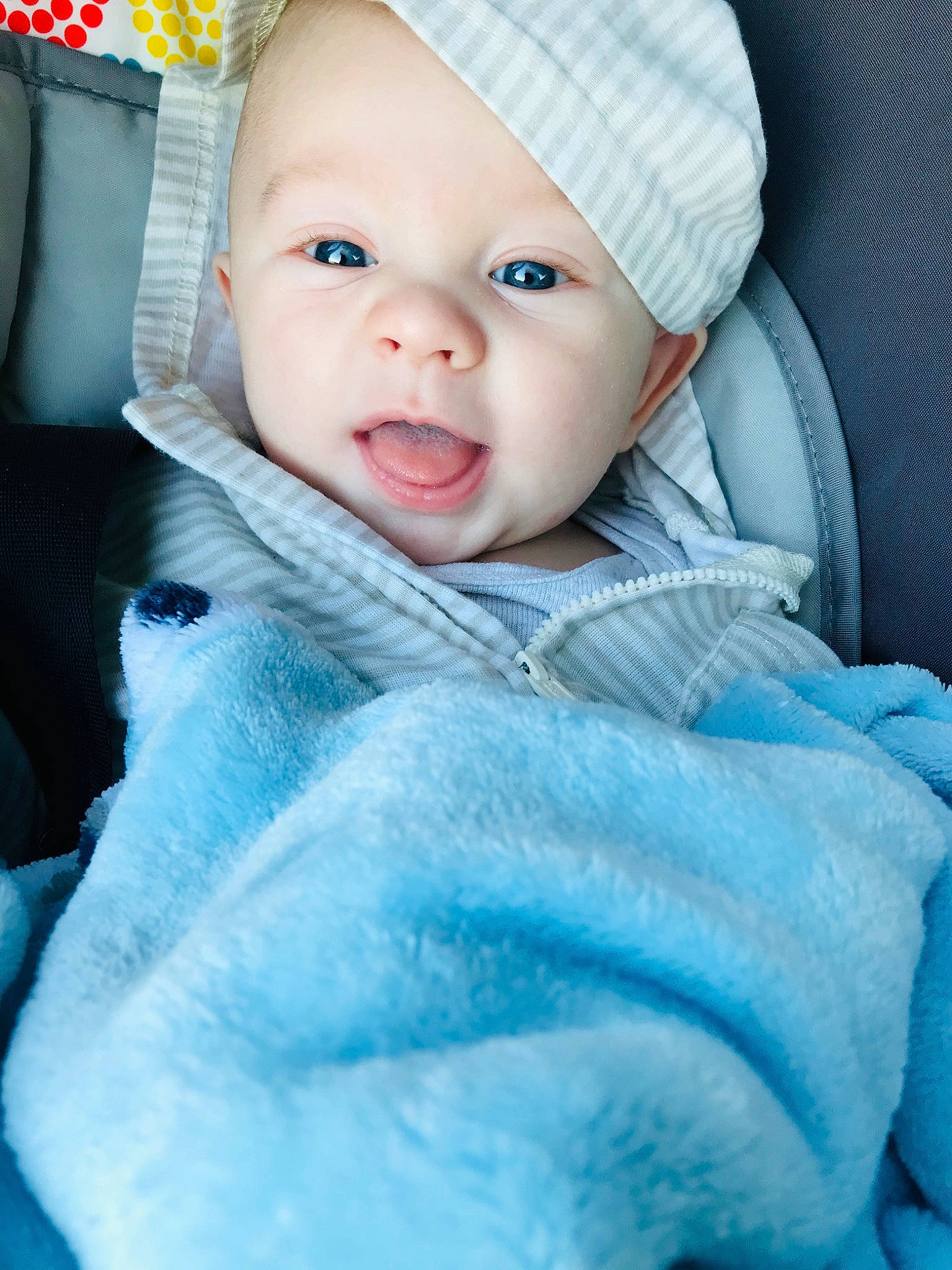 Leeland is registered to the contest to win money with this photo: baby, baby_products, beauty, blue, car_seat, cheek, child, eye, face, fur, head, headwear, lip, person, photograph, pink, portrait_photography, product, skin, smile