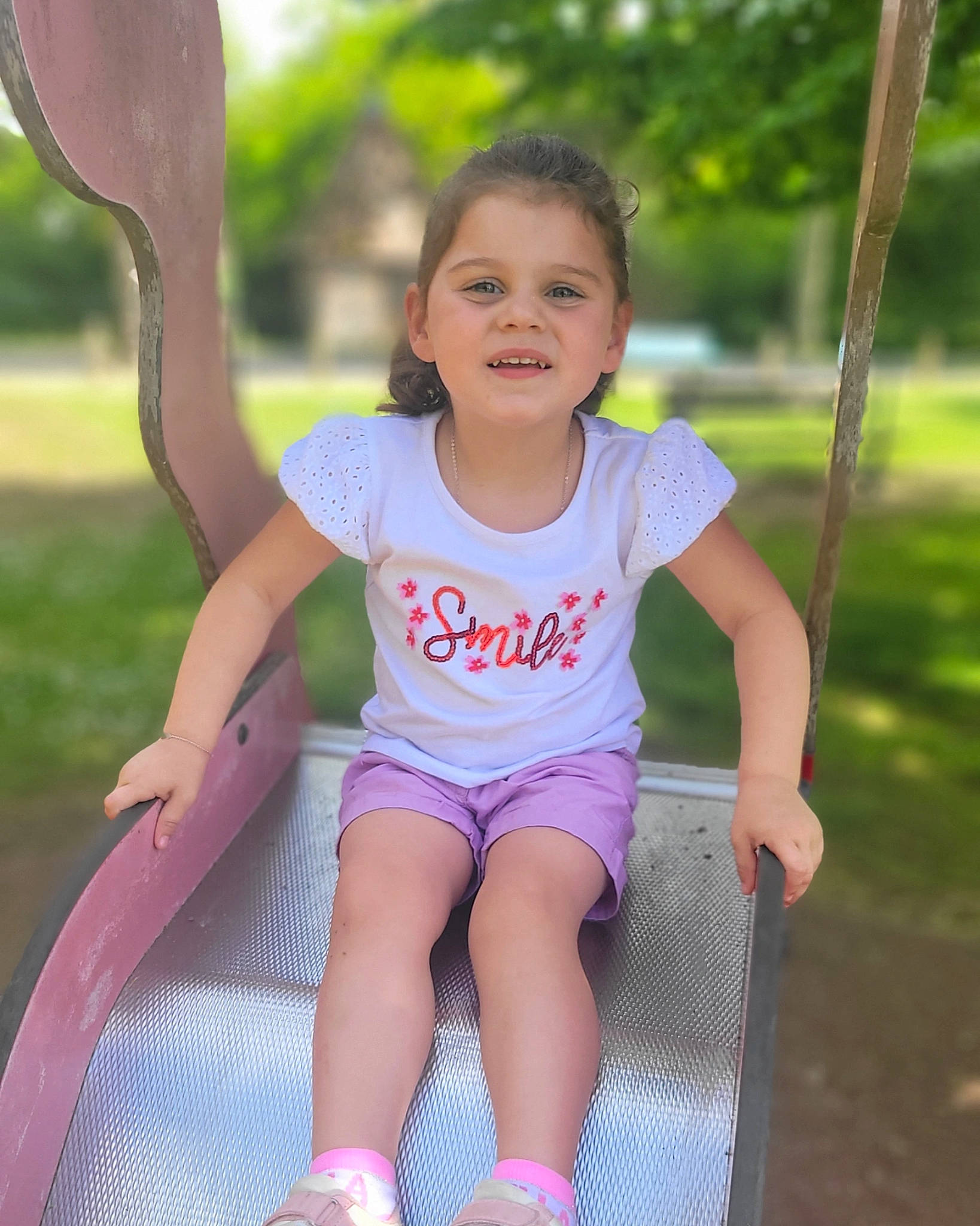 Layana participe au concours pour gagner de l'argent avec cette photo : baby_toddler_clothing, child, fun, grass, happy, human_leg, human_settlement, joy, leg, leisure, magenta, outdoor_play_equipment, people_in_nature, person, pink, playground, recreation, skin, summer, t_shirt
