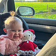 Aëlys participe au concours pour gagner de l'argent avec cette photo : baby, child, smiling, doll, crochet_doll, car_seat, car_interior, side_mirror, green_field, window, sunlight, pink_outfit, plush_blanket, topknot, rosy_cheeks, seatbelt, happy, portrait, travel, toy