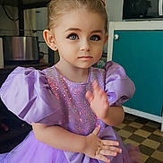 Maïa a rejoint le concours — aidez-le/la à gagner de superbes lots ! child, girl, princess, tiara, lavender_dress, puffy_sleeves, sequins, tulle_skirt, indoor, kitchen, appliances, microwave, toaster, cup, earrings, floor_tiles, decor, portrait, cute, waving_hand