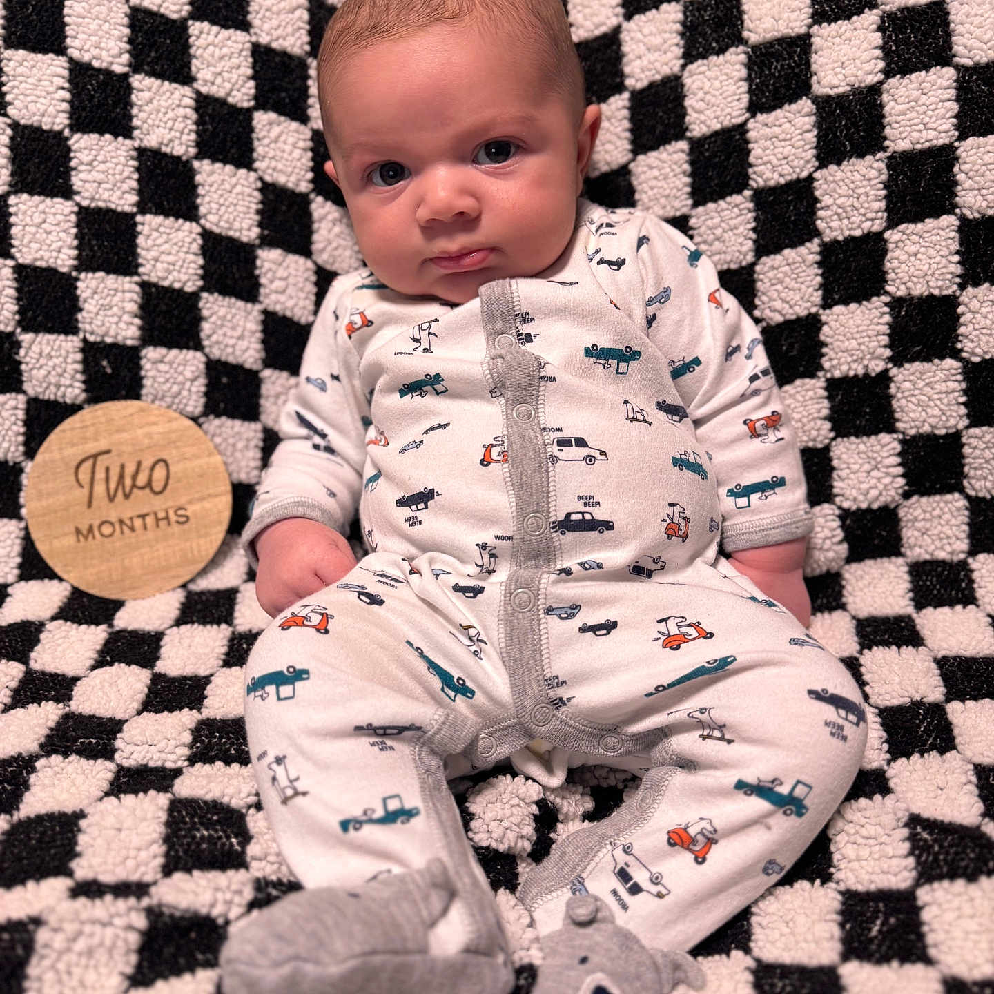 Kandon joined the competition — help win amazing prizes! baby, baby_clothes, baby_slippers, checkered_pattern, child, cute, eyes, face, footwear, hands, indoors, infant, onesie, person, plush_blanket, portrait, sitting, soft_texture, two_months, wooden_sign