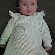 Summer joined the competition — help win amazing prizes! baby, infant, onesie, white_clothing, couch, indoor, pacifier, blue_eyes, curious, portrait, child, young, sitting, soft_lighting, human, cute, cozy, fabric_texture, face, small_hands