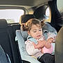 Charli participe au concours pour gagner de l'argent avec cette photo : baby, baby_doll, car_interior, car_seat, child, child_safety, clothing, cute, headrest, indoors, interior, person, pigtails, seat, seatbelt, toddler, toy, transportation, window, young_child