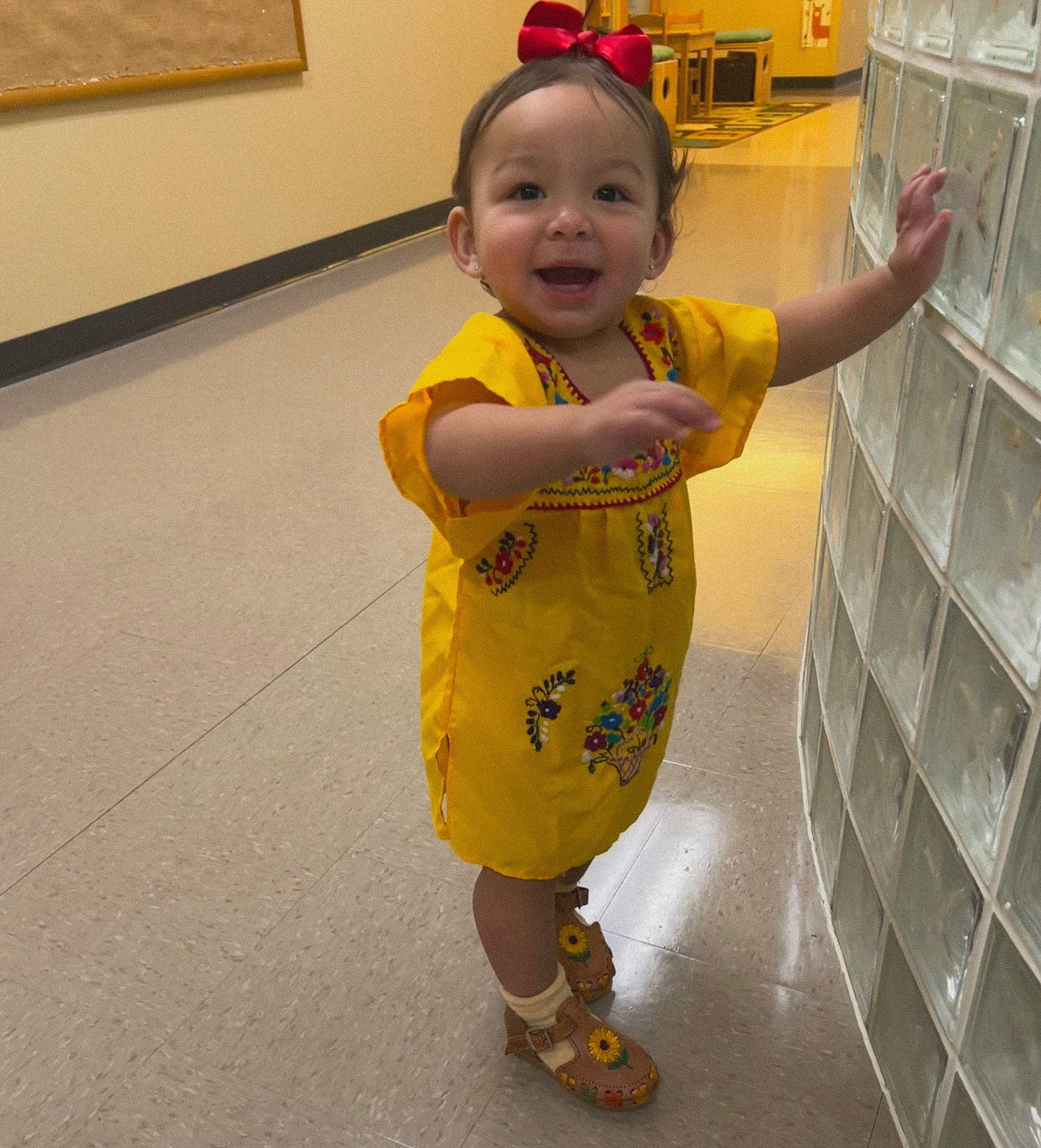 Isabella is registered to the contest to win money with this photo: arm, baby, baby_toddler_clothing, child, eye, face, facial_expression, floor, flooring, fun, hair, happy, nose, organ, person, skin, sleeve, smile, t_shirt, thumb