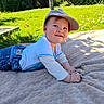 baby, blanket, cap, casual_clothing, child, face, flower, grass, greenery, happy, jeans, nature, outdoor, playful, portrait, smile, summer, sunlight, toddler, white_shirt
