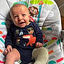 baby, infant, cast, leg_cast, smiling, blue_onesie, animal_print, baby_chair, monkey, toucan, palm_tree, colorful, indoor, happy, cute, child, sitting, clothing, patterned, playful