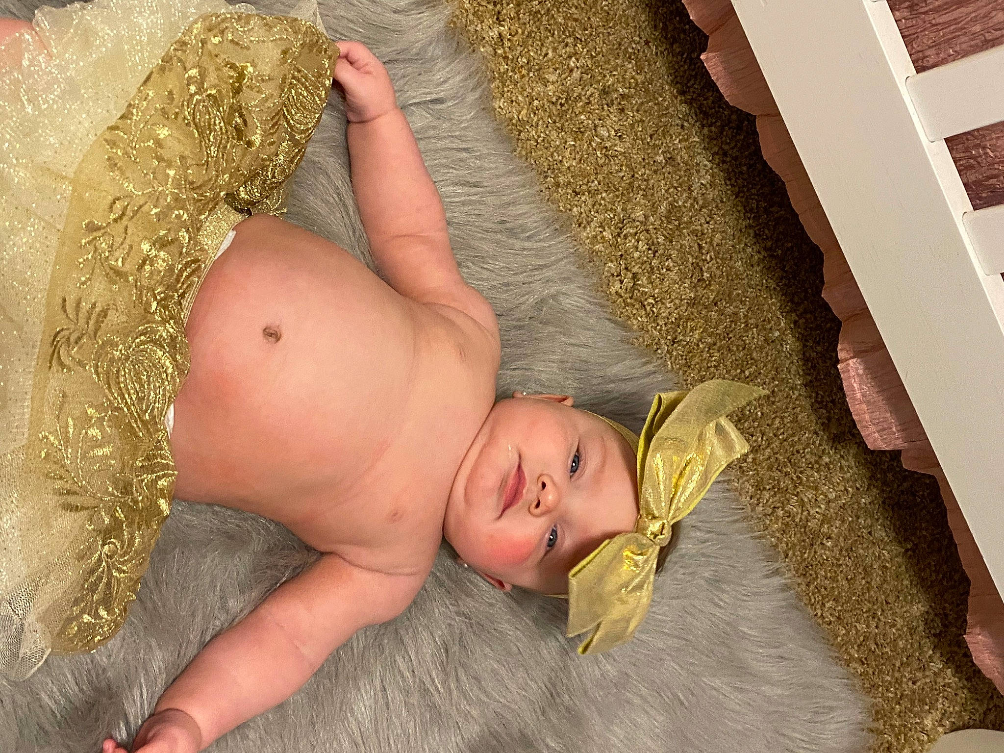 Kinsley is registered to the contest to win money with this photo: abdomen, baby, barefoot, blond, chest, fawn, foot, fun, grass, head, headwear, human_body, human_leg, leg, navel, people_in_nature, person, thigh, toe, toy