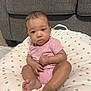 Ameriah joined the competition — help win amazing prizes! baby, infant, child, pink_onesie, cushion, polka_dots, sofa, gray_sofa, indoor, floor, feet, hands, face, curious, sitting, home, cute, portrait, young, person