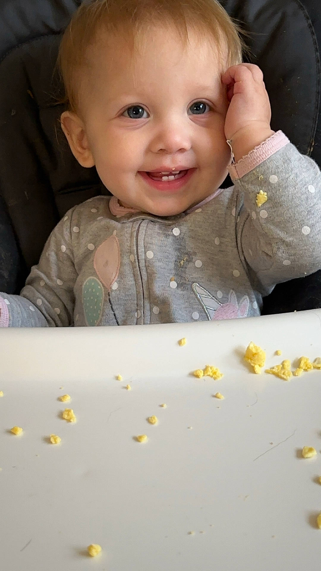 baby, bodypart, clothing, cutlery, eating, face, finger, food, furniture, hand, happy, head, laughing, person, photography, popcorn, portrait, smile, snack, spoon