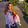 child, children, costume, cute, daylight, face_paint, friendship, heart, holding, jacket, outdoor, pavement, person, playful, school_bus, shoes, street, tree, wig, young